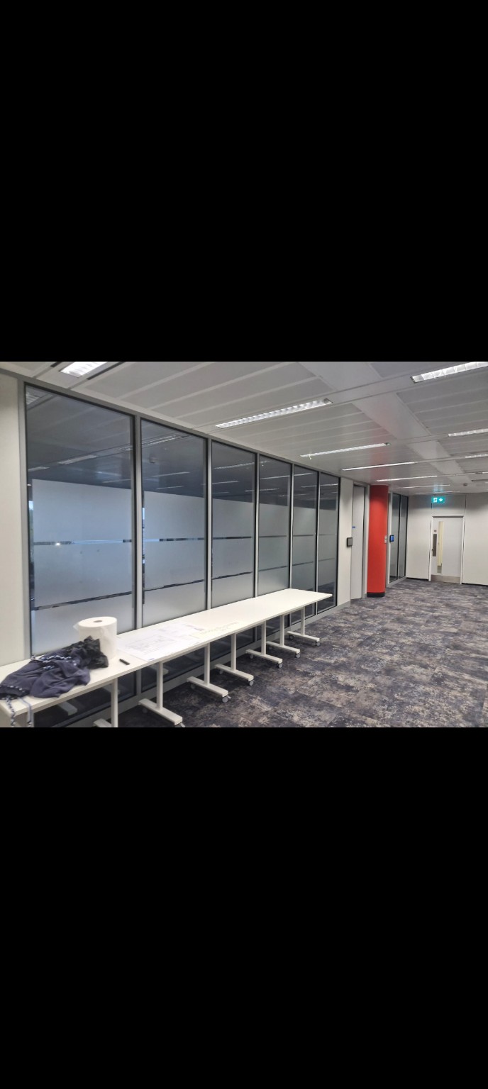 Frosted privacy band across a glazed corridor