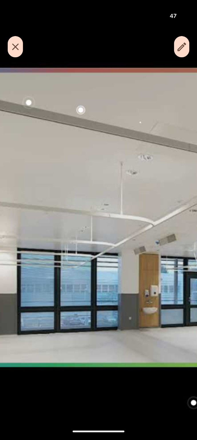 Curved white ceiling mounted cubicle track in a clinical room