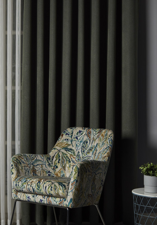 Dark blackout curtains in a furnished room