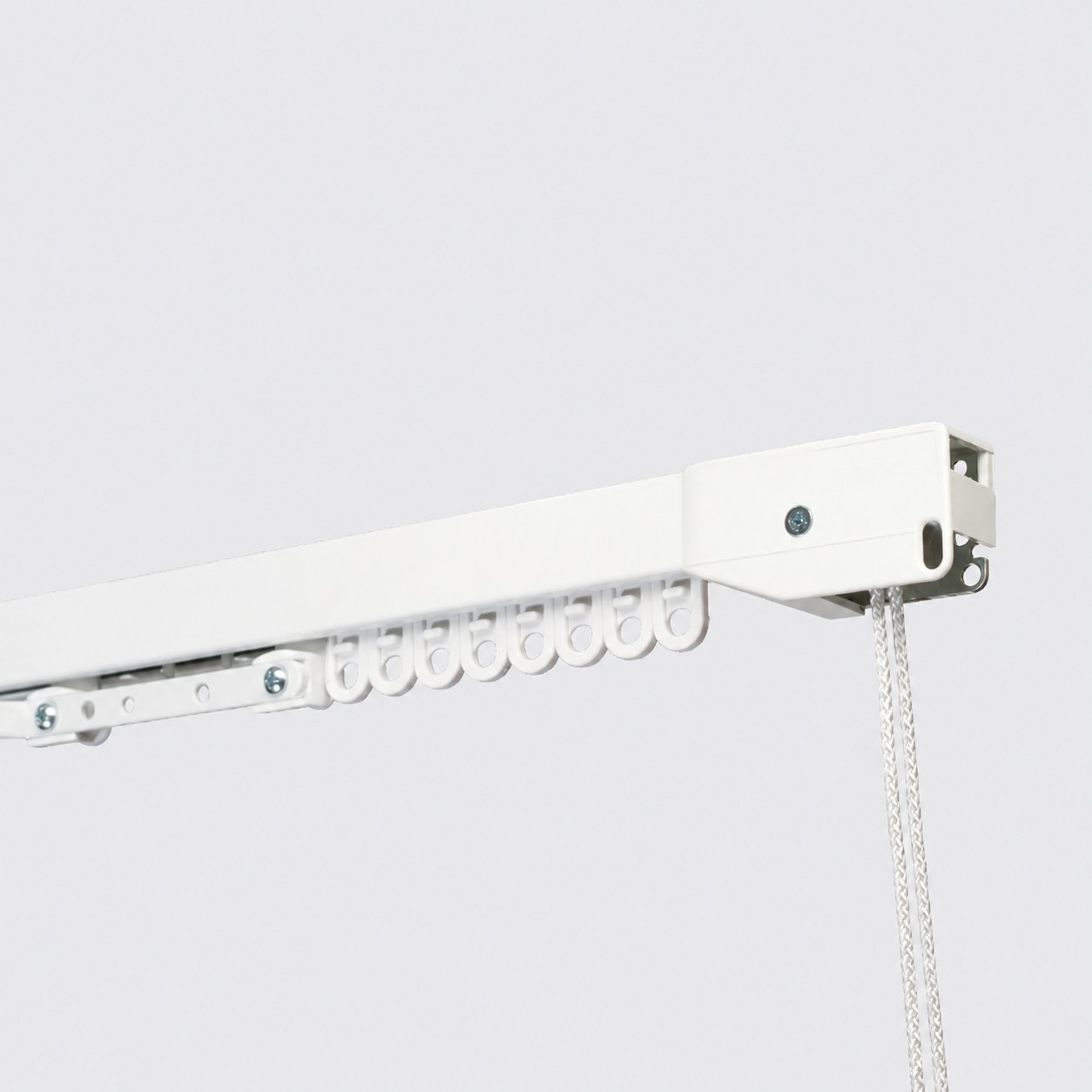 White cord drawn curtain track with operating cords and gliders